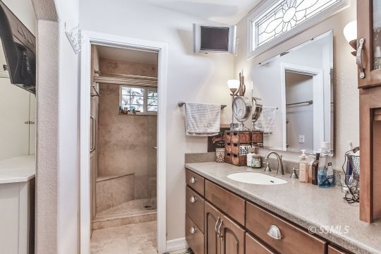 1220 Jennifer Court Ridgecrest, CA 93555 - Photo 24 of 34 a bathroom with a sink a vanity and a mirror