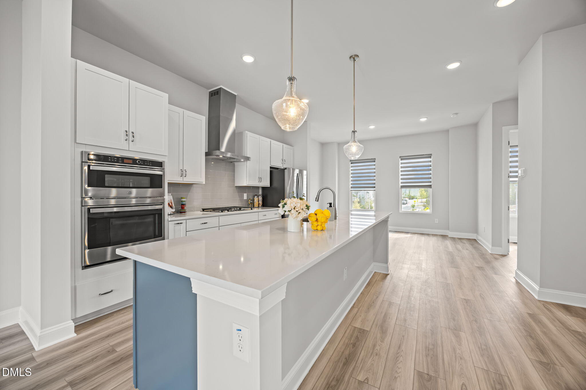 501 Hedrick Ridge Road Cary, NC 27519 - Photo 11 of 47 a large kitchen with stainless steel appliances kitchen island granite countertop a stove a sink a refrigerator and a wooden floors