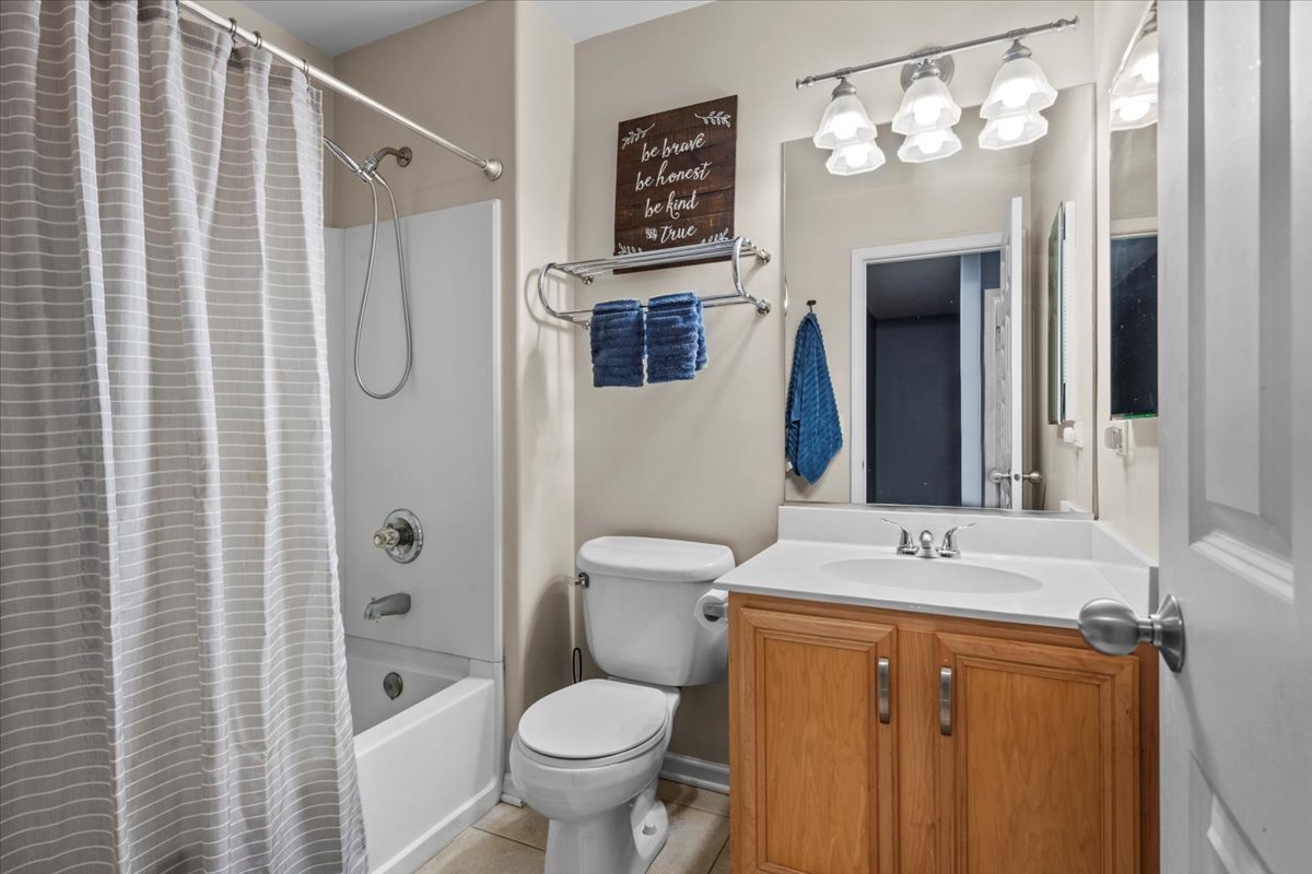 907 Main Street Batavia, IL 60510 - Photo 18 of 20 a bathroom with a sink toilet mirror and shower