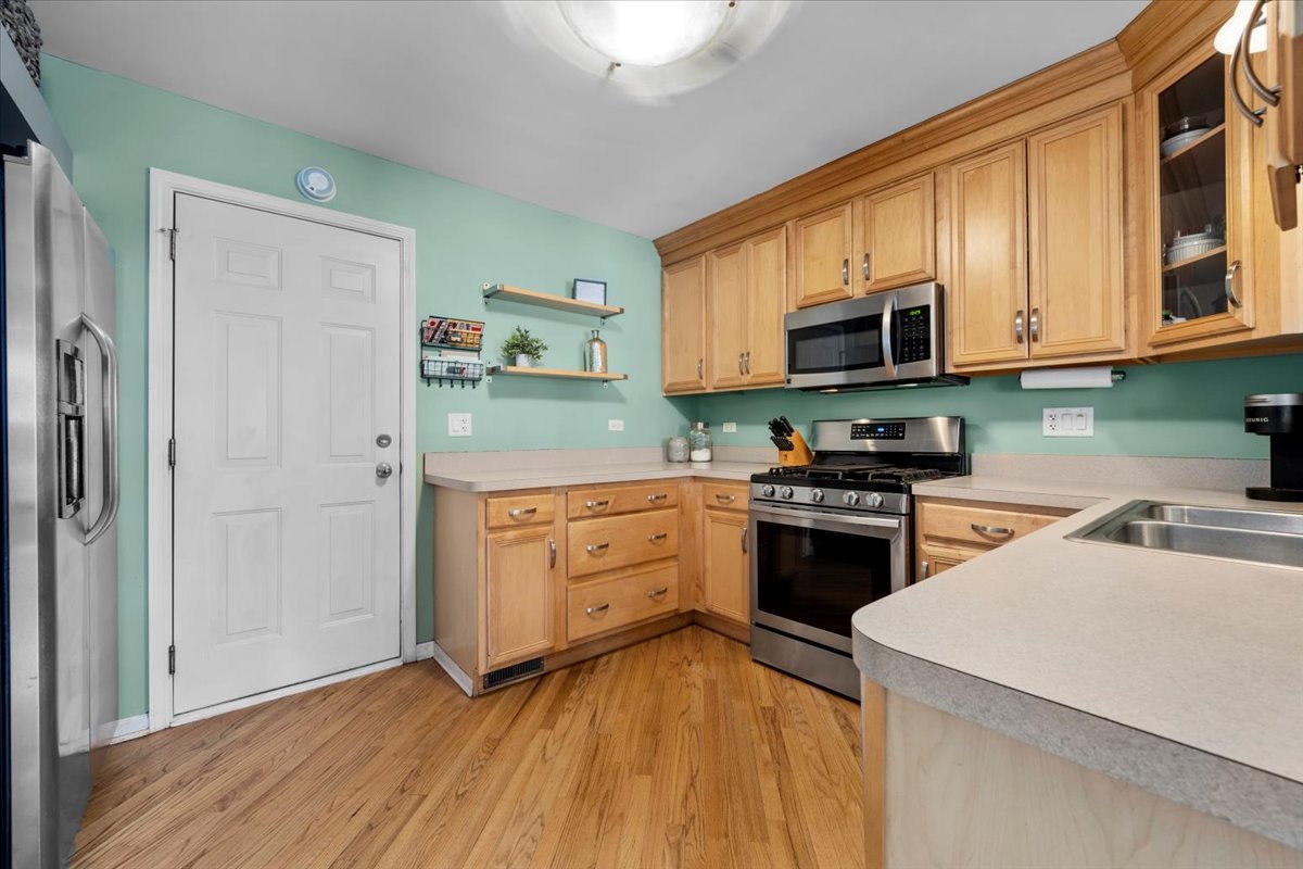 907 Main Street Batavia, IL 60510 - Photo 8 of 20 a kitchen with stainless steel appliances granite countertop a stove a sink and a refrigerator