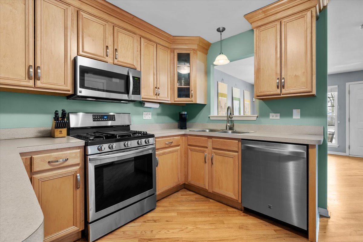907 Main Street Batavia, IL 60510 - Photo 9 of 20 a kitchen with stainless steel appliances granite countertop a stove and a microwave