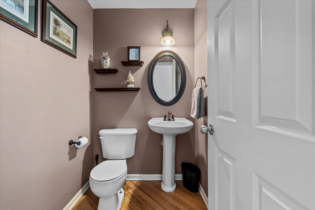 907 Main Street Batavia, IL 60510 - Photo 10 of 20 a bathroom with a toilet sink and mirror