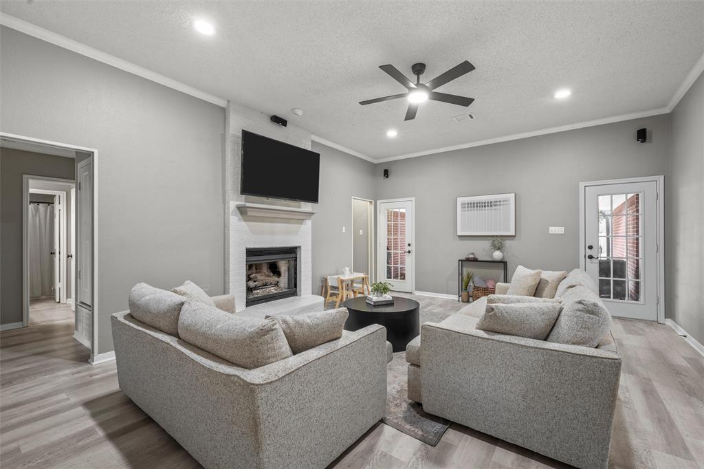 112 Briar Ridge Drive Hewitt, TX 76643 - Photo 4 of 15 Spacious room featuring a fireplace with a white mantel, ceiling fan, wood-finish flooring, and recessed lighting
