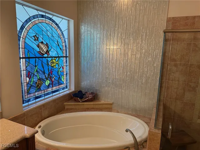 a white bath tub with a shower