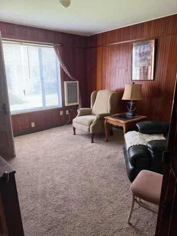 a bedroom with a bed and curtain