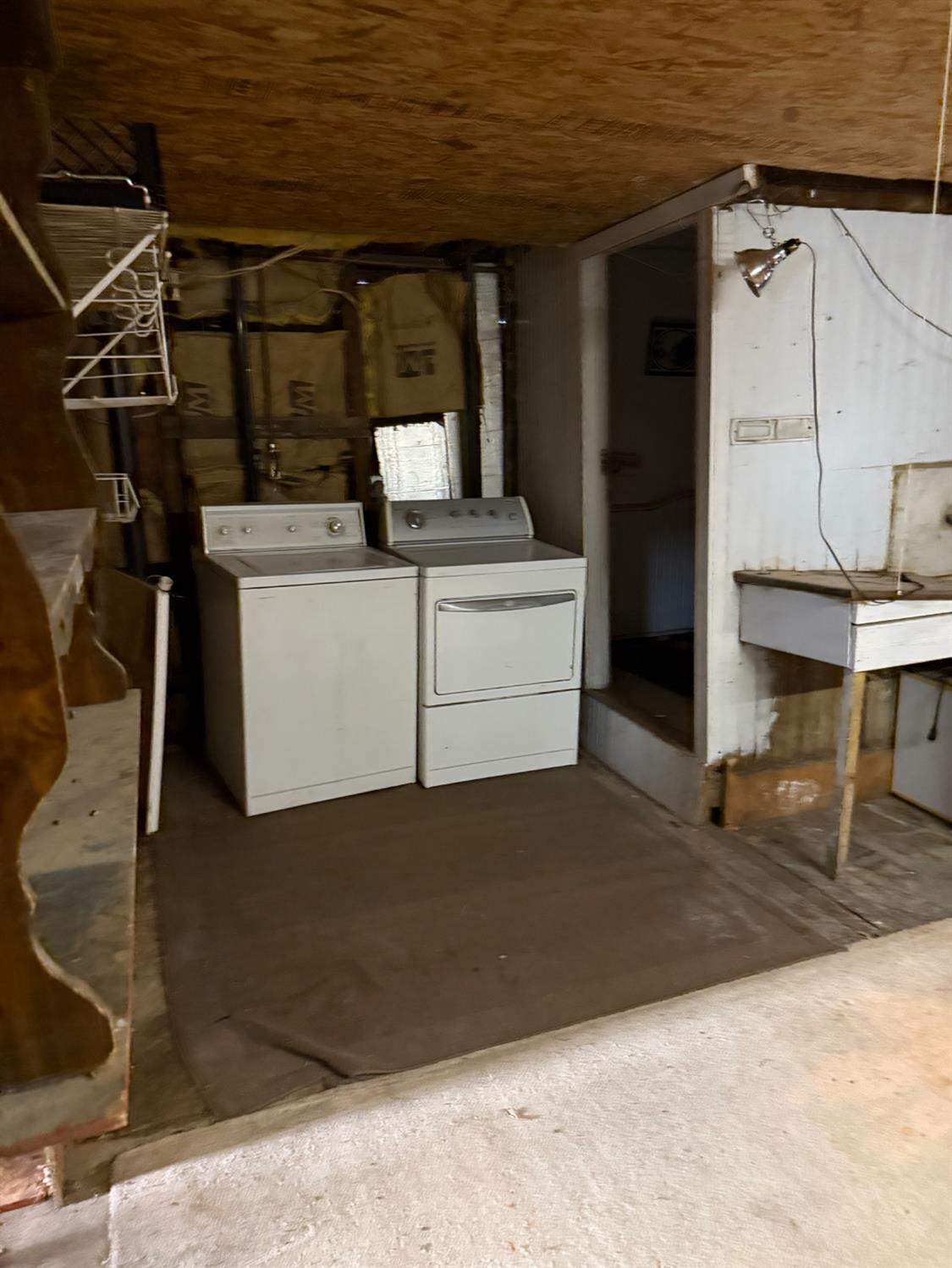 301 B Street Isleton, CA 95641 - Photo 28 of 30 a room with water heater and wooden cabinets