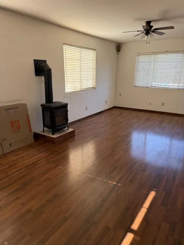 a view of a livingroom with wooden floor and a window