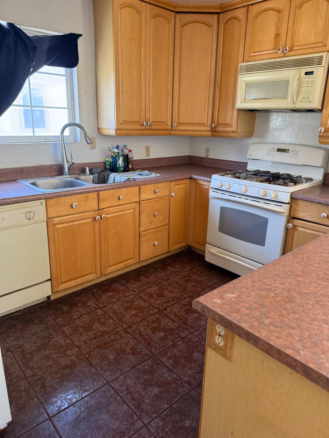 301 B Street Isleton, CA 95641 - Photo 9 of 30 a kitchen with granite countertop a sink a stove and cabinets
