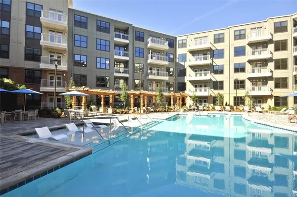 a view of a swimming pool with outdoor seating