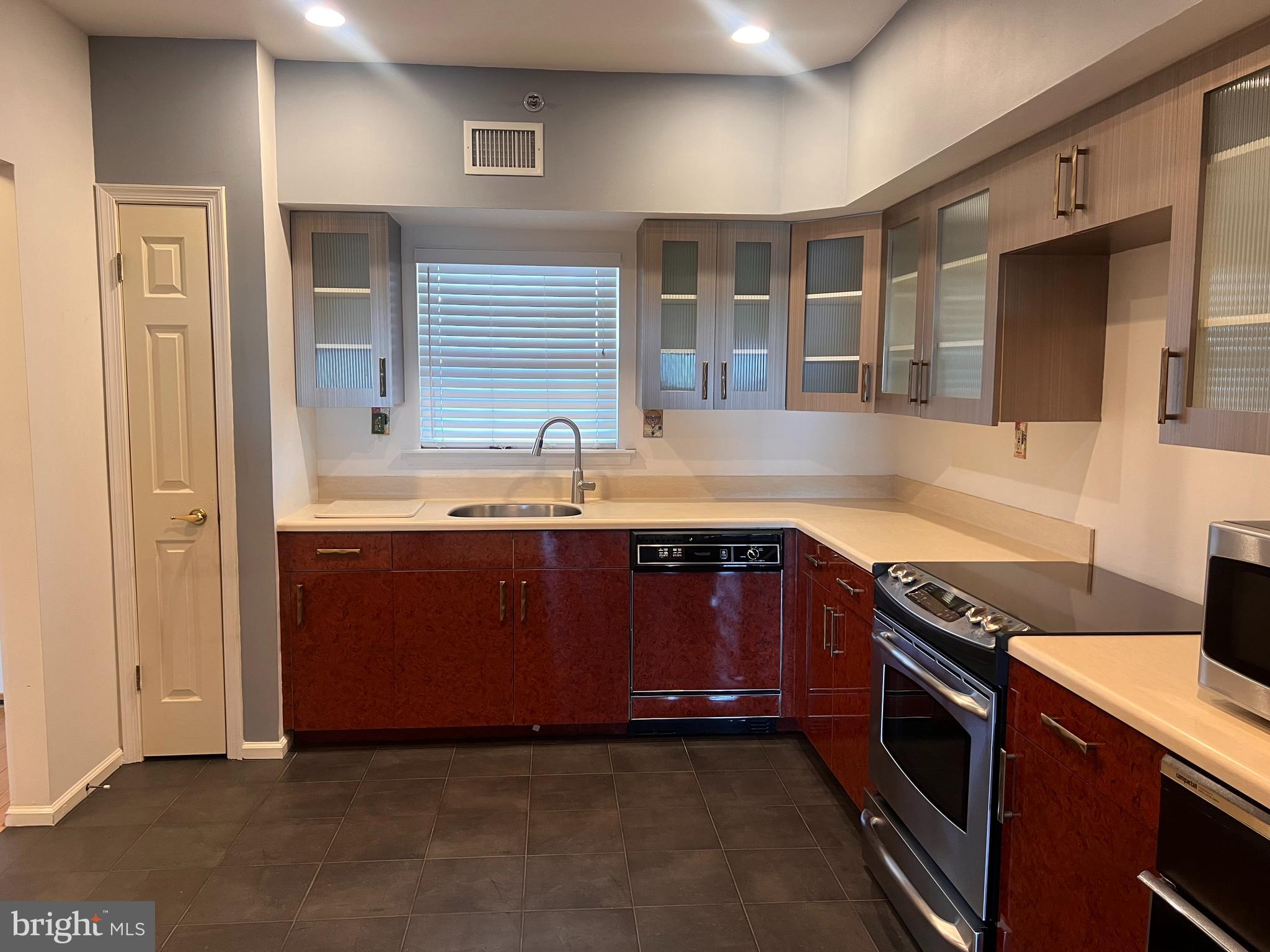 6073 Main Street Voorhees, NJ 08043 - Photo 2 of 16 a kitchen with stainless steel appliances granite countertop a sink stove and cabinets