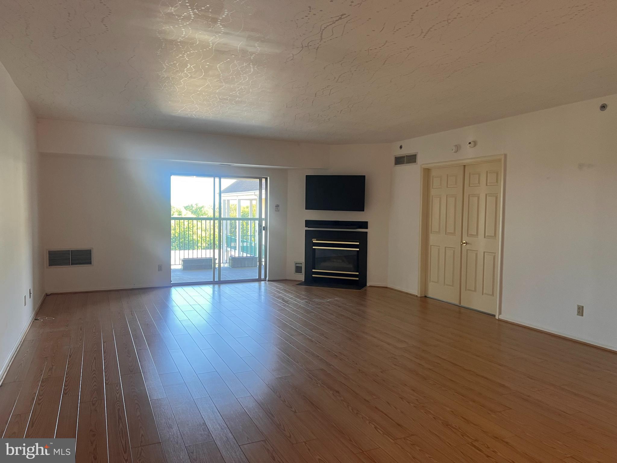 6073 Main Street Voorhees, NJ 08043 - Photo 3 of 16 a view of empty room with wooden floor and fan