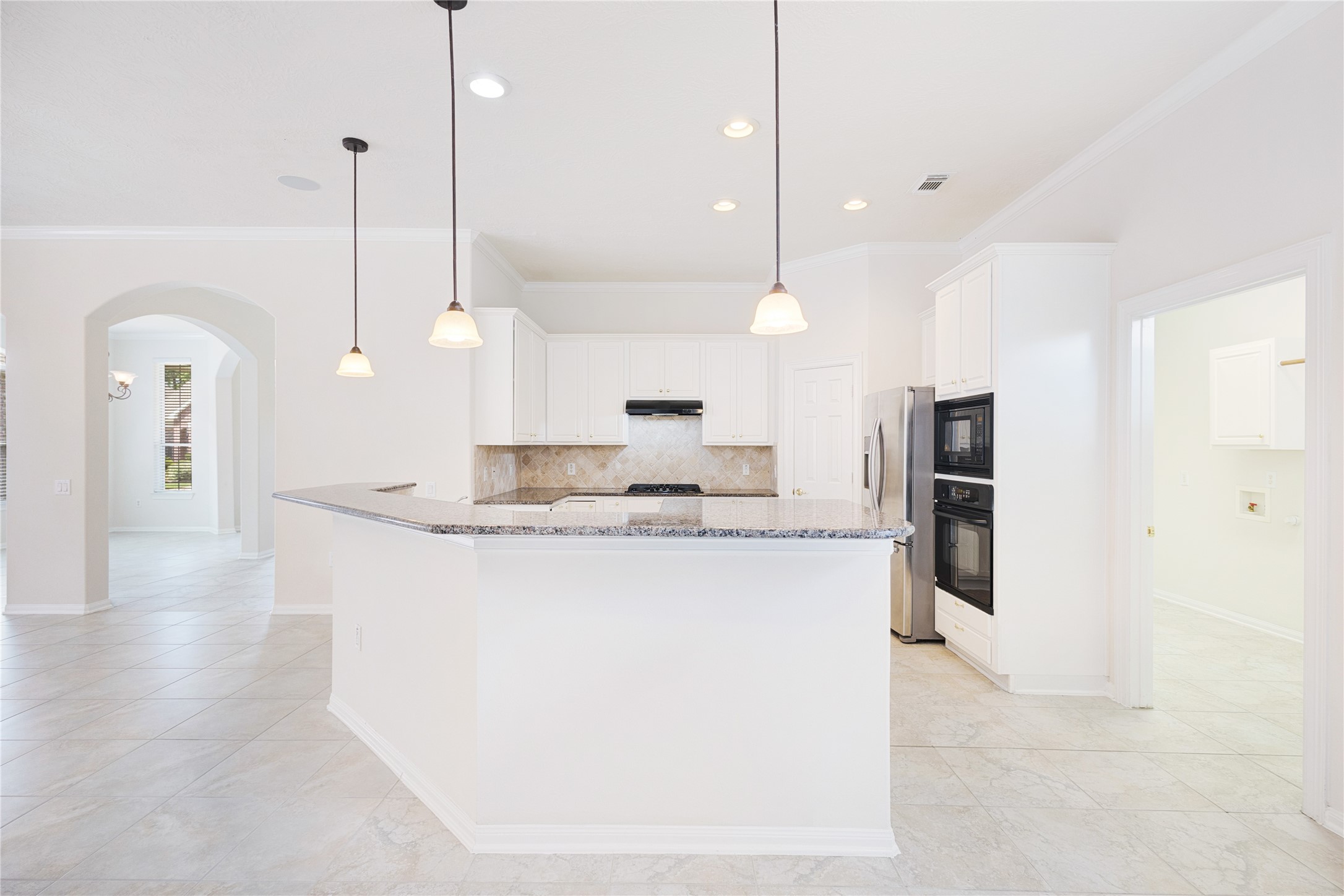 43 Tarrytown Way Conroe, TX 77384 - Photo 18 of 41 a view of a kitchen with kitchen island a counter top space a sink stainless steel appliances and cabinets