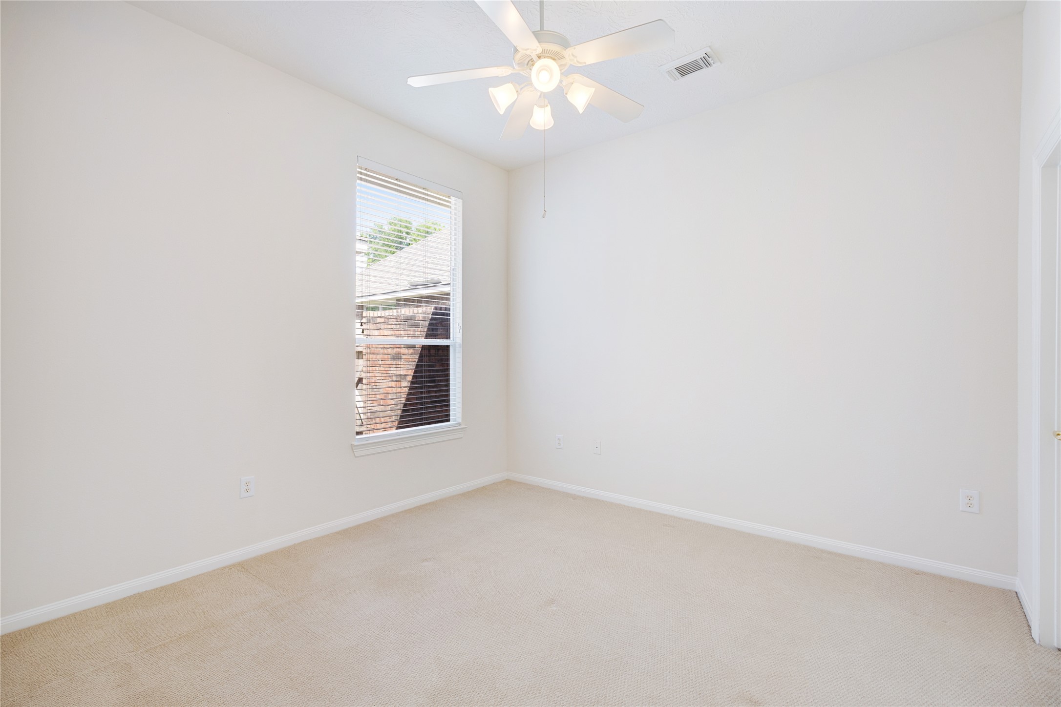 43 Tarrytown Way Conroe, TX 77384 - Photo 32 of 41 an empty room with a window and a fan