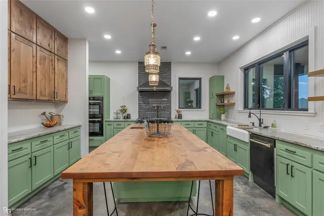 a kitchen with sink stove and cabinets