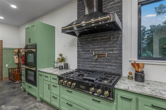a kitchen with granite countertop stainless steel appliances and wooden cabinets