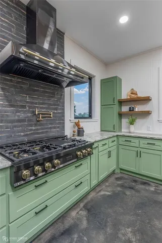 a kitchen with a stove and cabinets