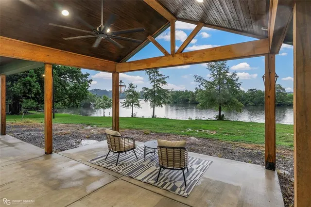 a patio with glass top table and chairs