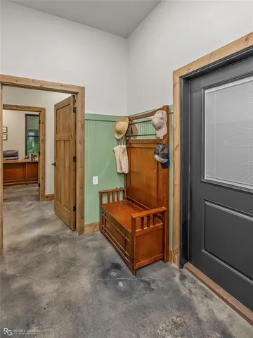 a dining room with furniture a chandelier and kitchen view