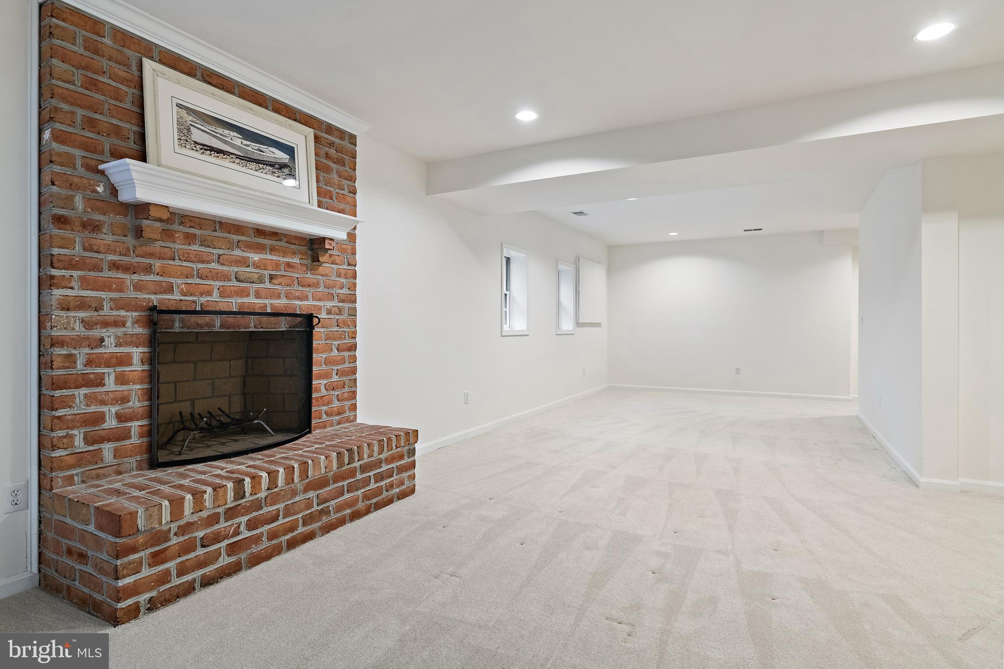 150 South River Landing Road Edgewater, MD 21037 - Photo 36 of 50 a living room with furniture a fireplace and a ceiling fan