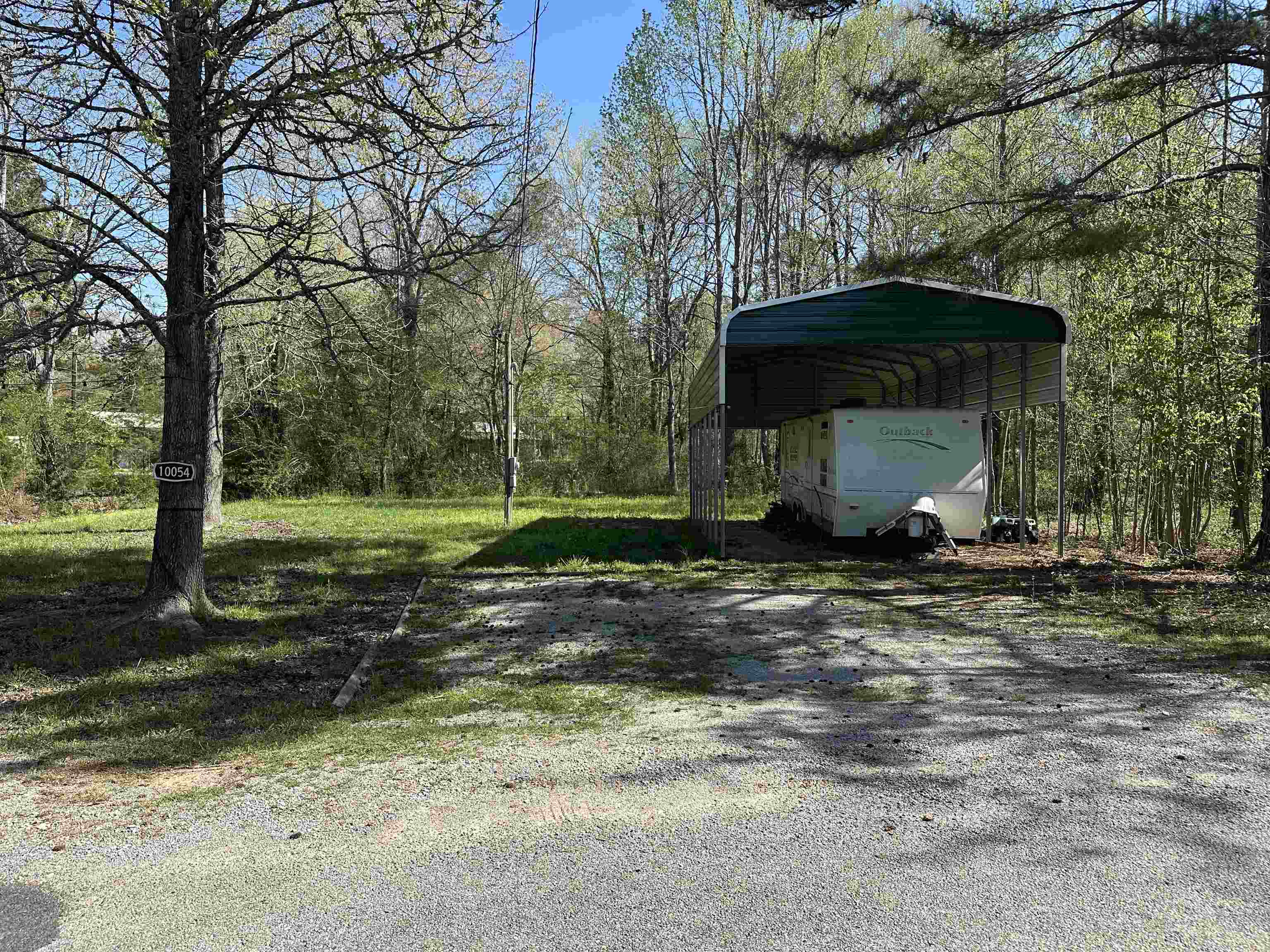 54 Campfire Cove, Unit C54 Middleton, TN 38052 - Photo 1 of 15 a view of a wooden house with a yard and large trees