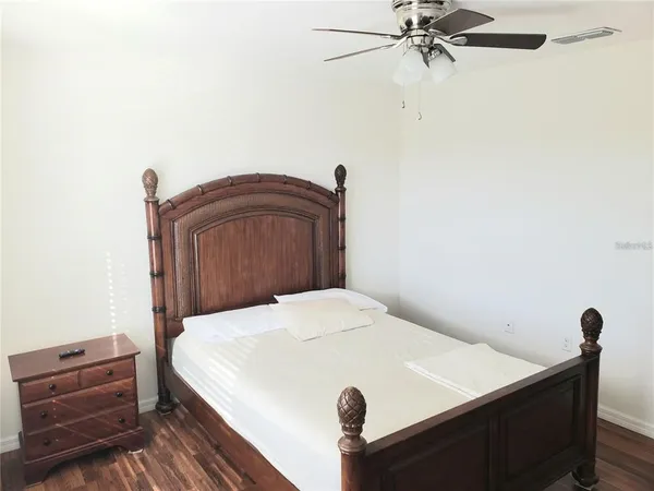 a bedroom with a bed and a dresser
