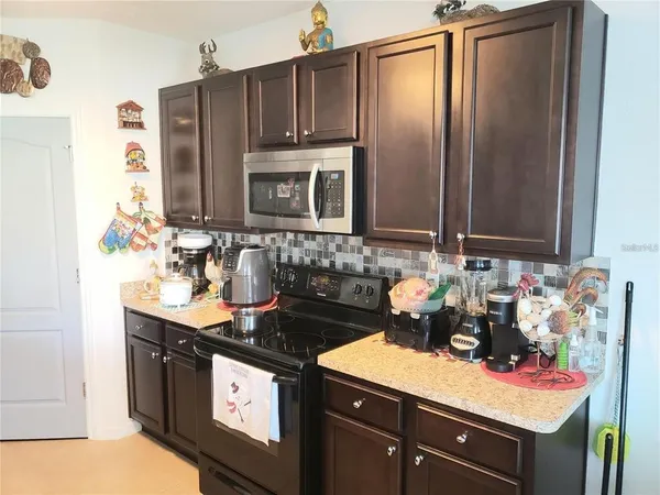 a kitchen with stainless steel appliances a sink stove and cabinets