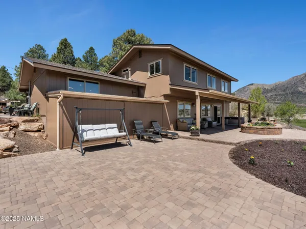 a view of a house with patio and a yard