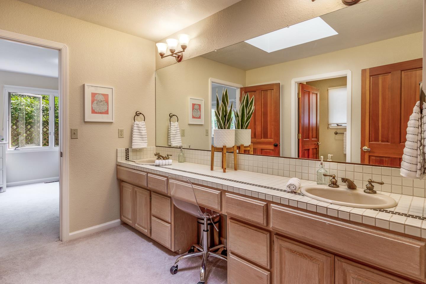 480 Hidden Valley Road Soquel, CA 95073 - Photo 26 of 72 a spacious bathroom with a double vanity sink a mirror and a bathtub