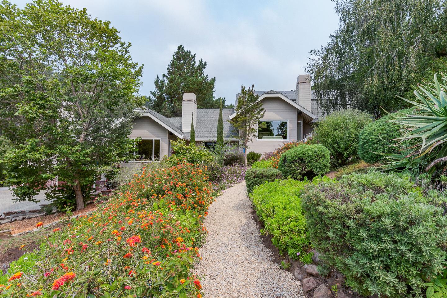 480 Hidden Valley Road Soquel, CA 95073 - Photo 5 of 72 a front view of a house with a yard and flower plants