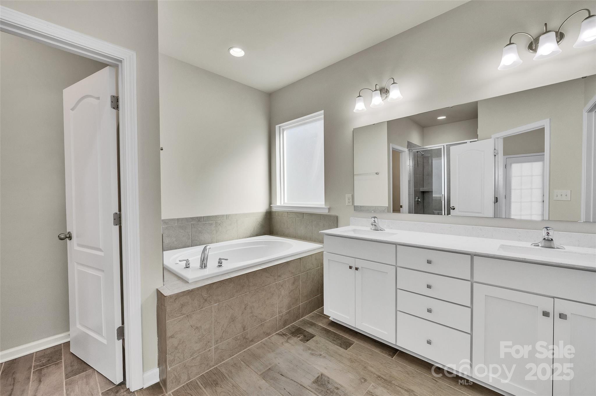 6130 Cloverdale Drive Tega Cay, SC 29708 - Photo 29 of 39 a bathroom with a double vanity sink mirror and bathtub