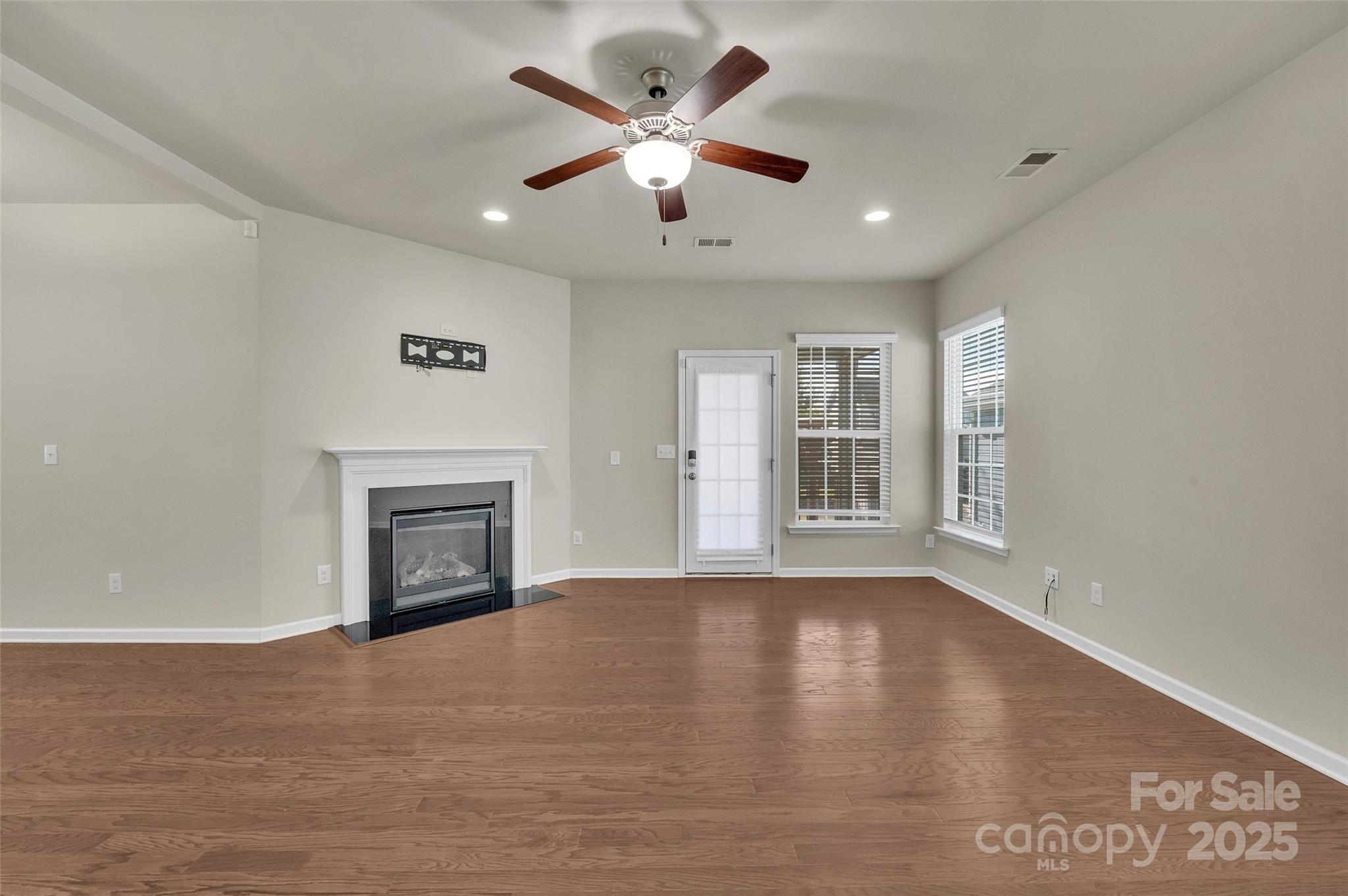 6130 Cloverdale Drive Tega Cay, SC 29708 - Photo 5 of 39 a view of an empty room with window and wooden floor