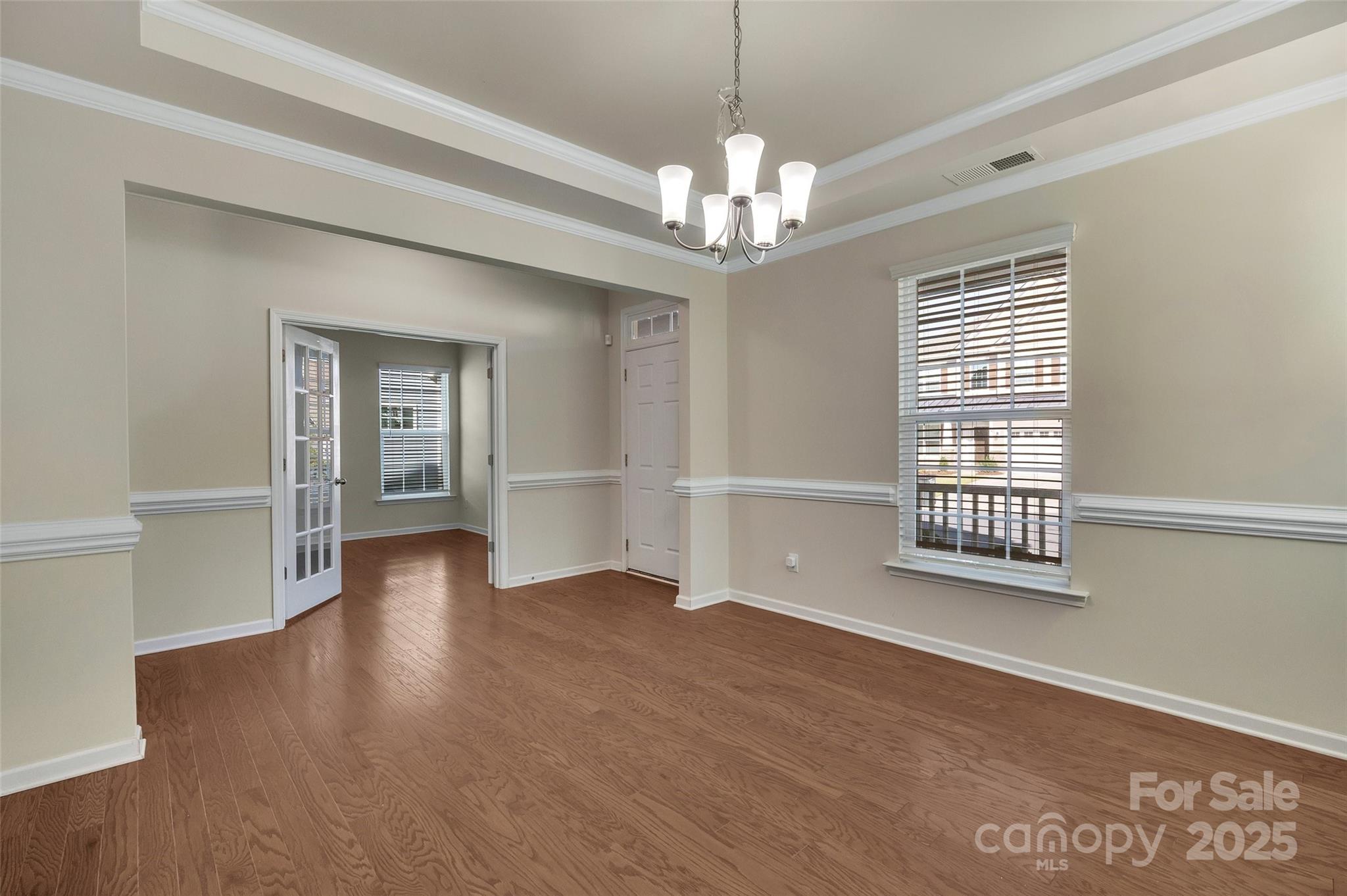 6130 Cloverdale Drive Tega Cay, SC 29708 - Photo 10 of 39 a view of an empty room with wooden floor and a window