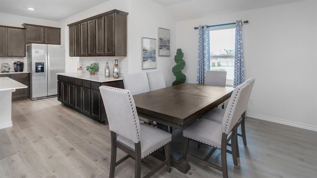 504 Carthage Street Caddo Mills, TX 75135 - Photo 9 of 17 a kitchen with a table and chairs in it
