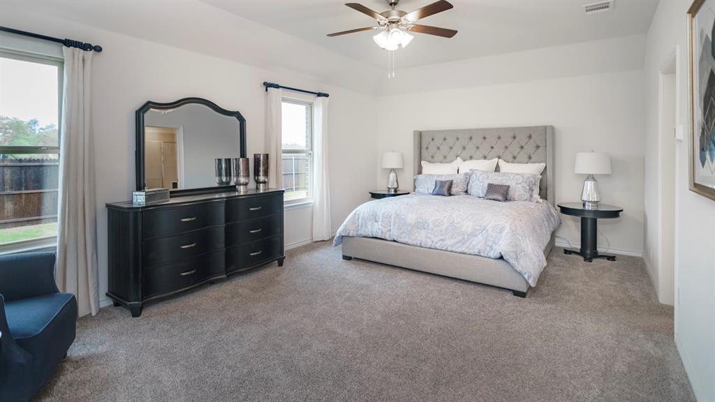 504 Carthage Street Caddo Mills, TX 75135 - Photo 12 of 17 a bedroom with a bed and a dresser