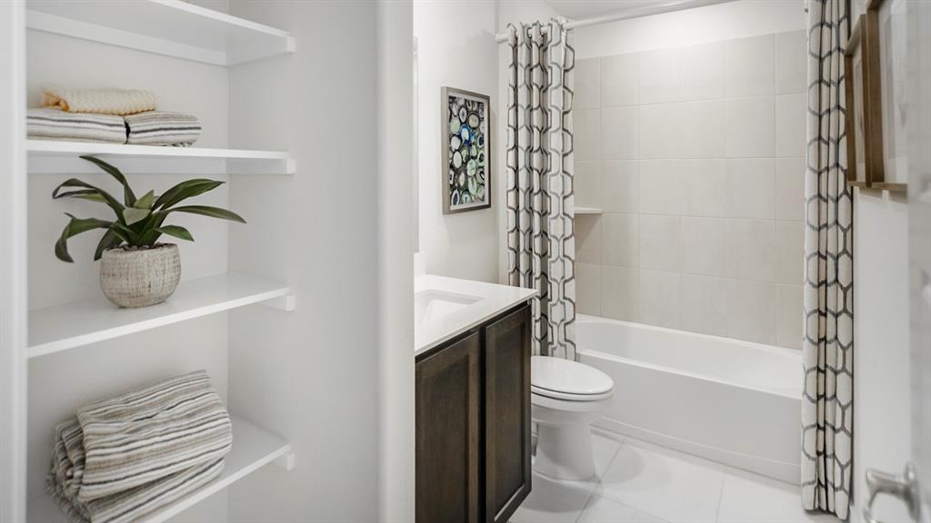 504 Carthage Street Caddo Mills, TX 75135 - Photo 2 of 17 a bathroom with a shower a toilet and a sink