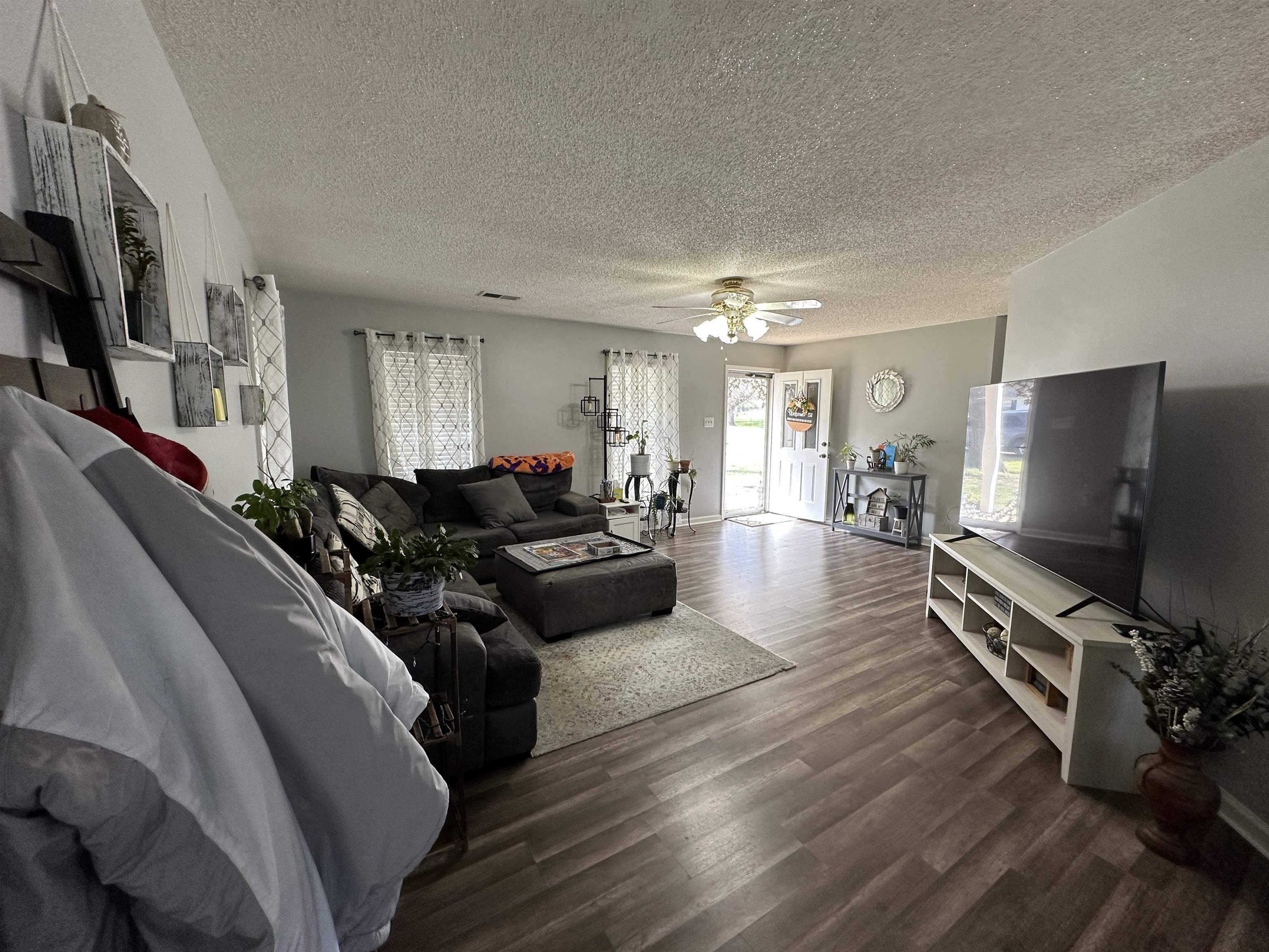 170 Lee Street Brighton, TN 38011 - Photo 2 of 11 Living area featuring ceiling fan, a textured ceiling, and wood finished floors