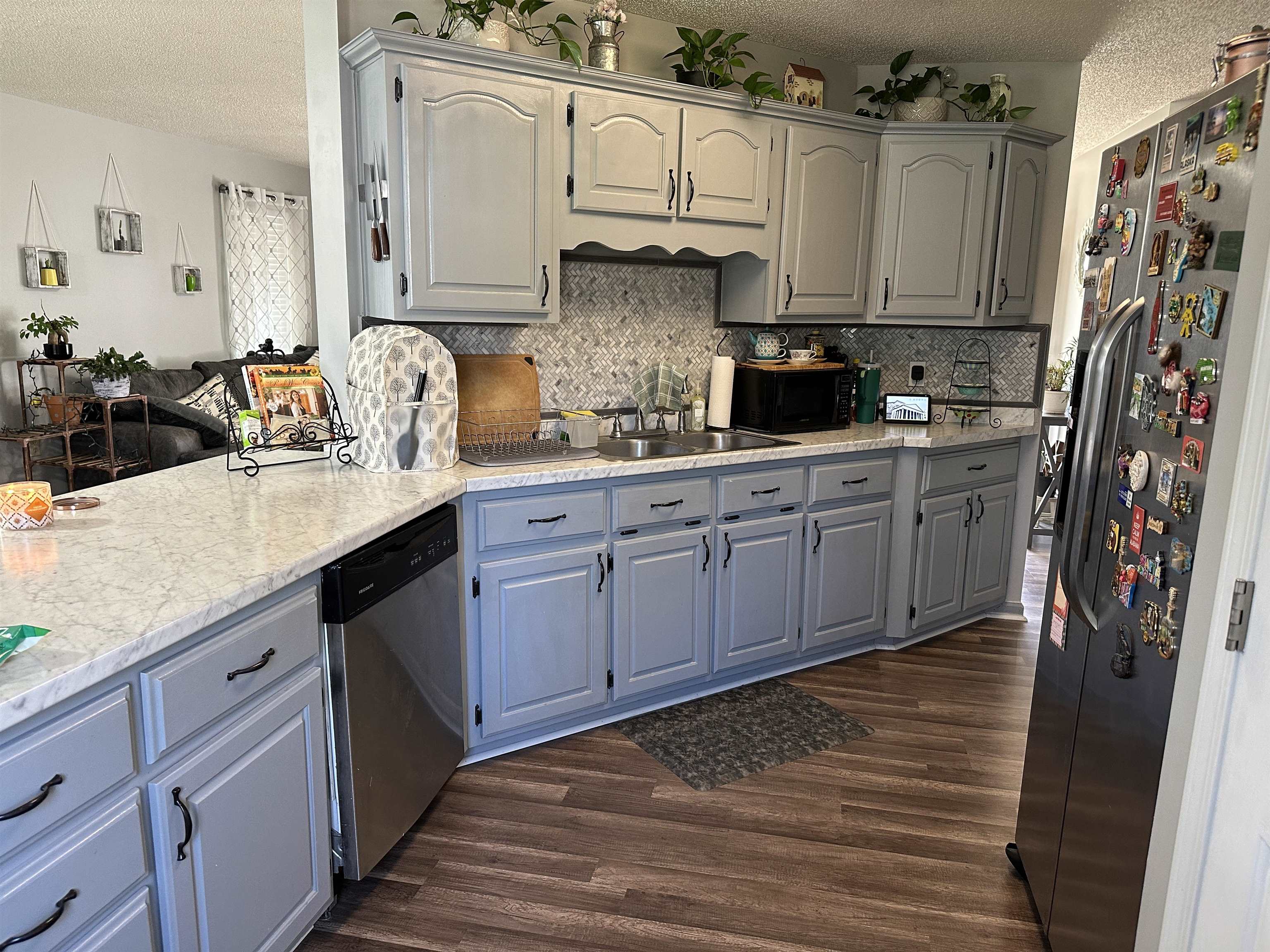 170 Lee Street Brighton, TN 38011 - Photo 4 of 11 Kitchen featuring decorative backsplash, a textured ceiling, a sink, and appliances with stainless steel finishes
