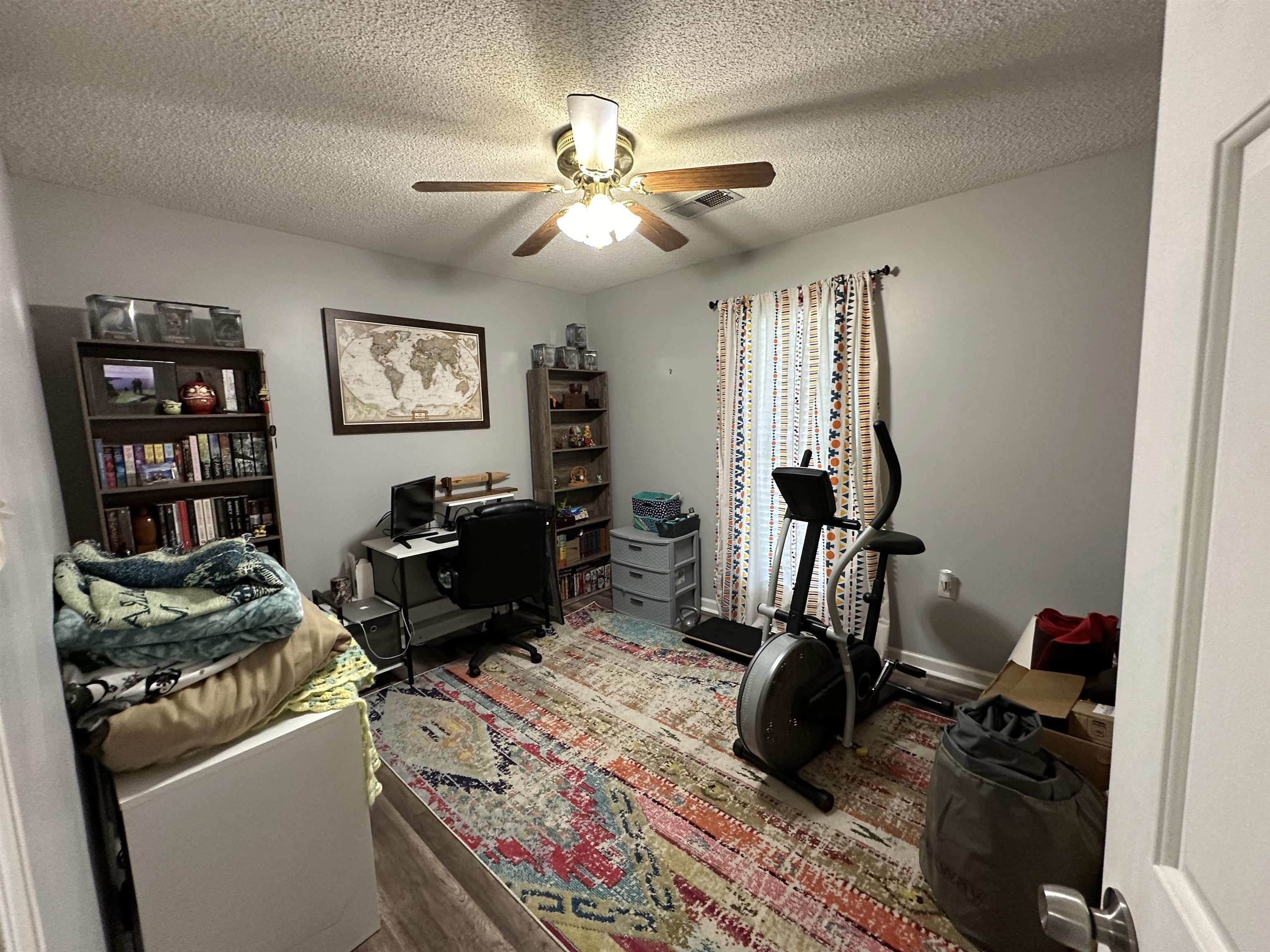 170 Lee Street Brighton, TN 38011 - Photo 6 of 11 Home office featuring visible vents, a textured ceiling, a ceiling fan, and wood finished floors