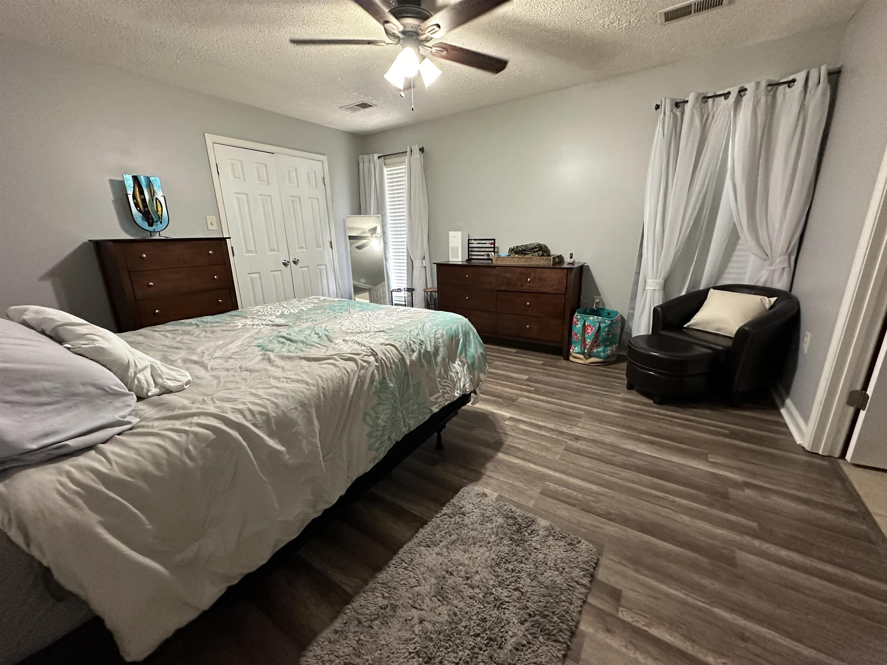 170 Lee Street Brighton, TN 38011 - Photo 8 of 11 Bedroom with a textured ceiling, wood finished floors, ceiling fan, and visible vents