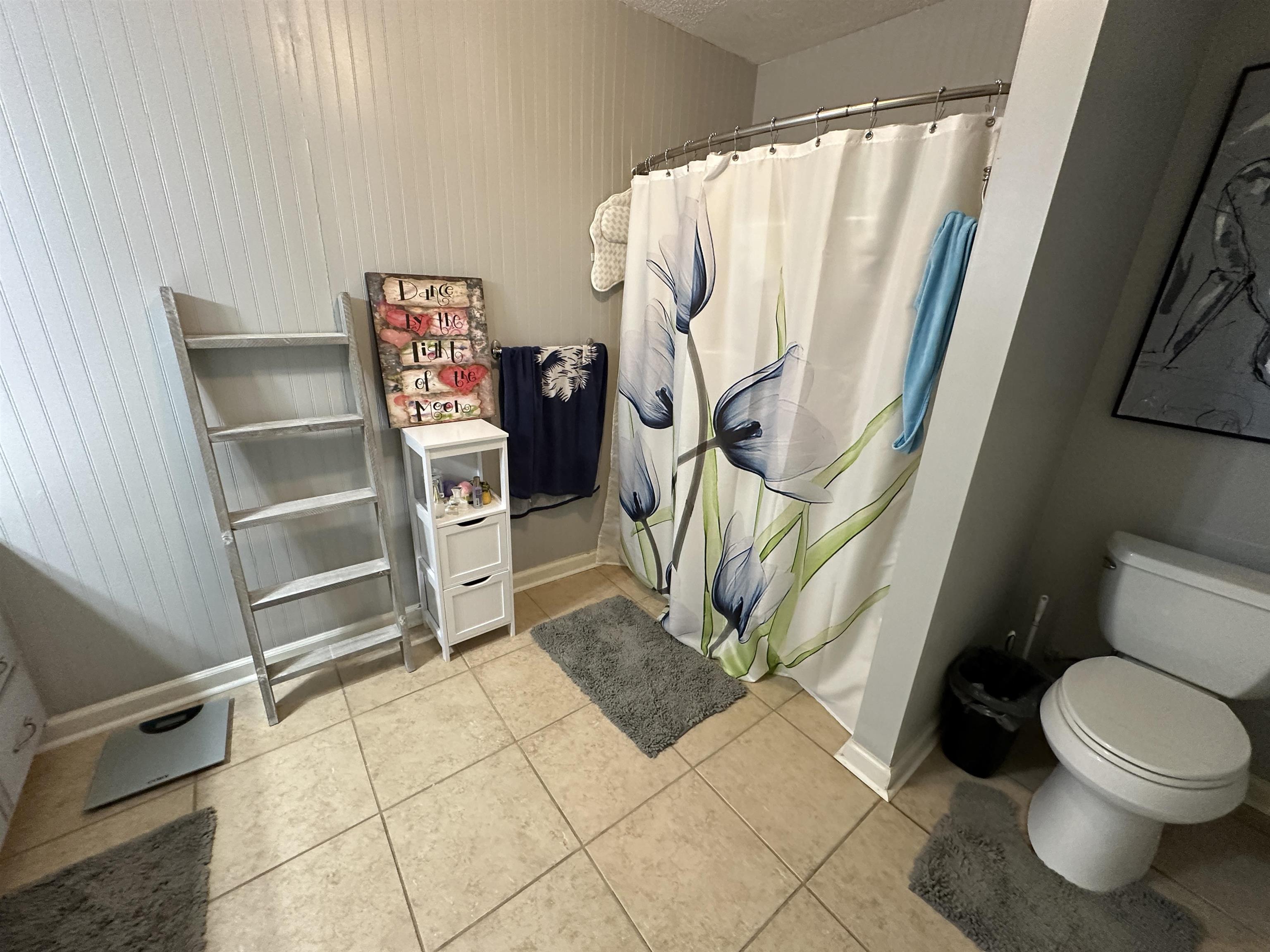 170 Lee Street Brighton, TN 38011 - Photo 9 of 11 Full bathroom with tile patterned floors, curtained shower, baseboards, and toilet