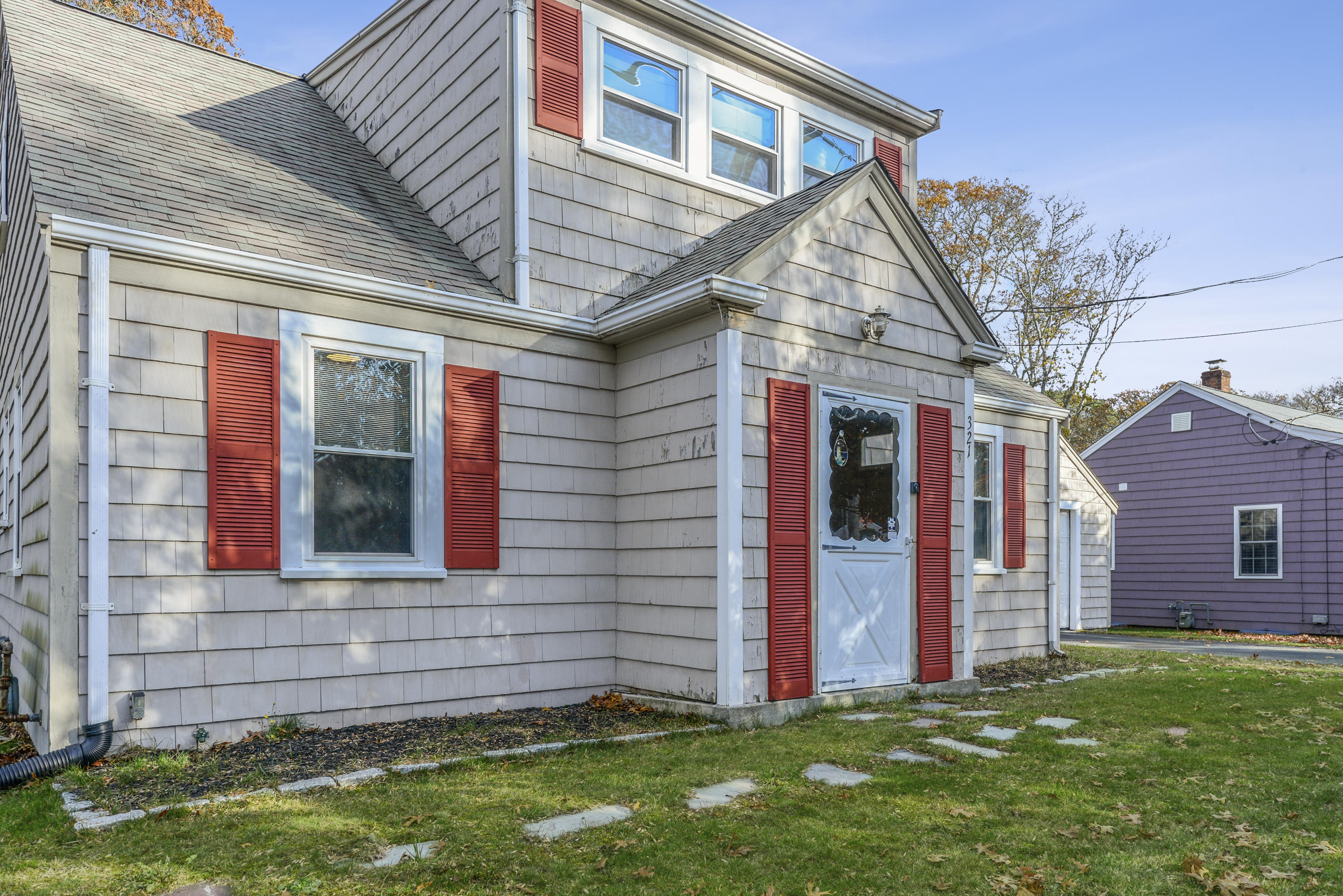 321 Shore Road Bourne, MA 02532 - Photo 3 of 21 a view of a house with a yard and stairs
