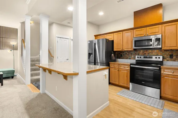 a kitchen with stainless steel appliances a refrigerator a stove a sink and a cabinets