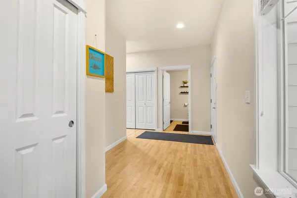 a view of a room with wooden floor and windows