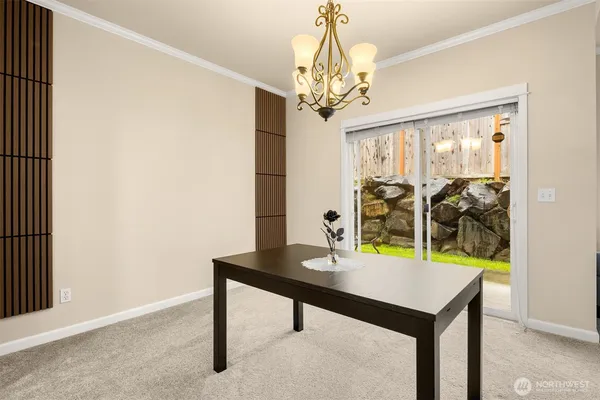 a view of a room with a table and chairs