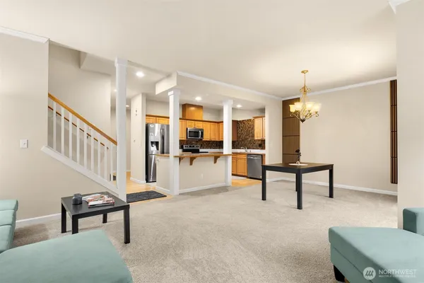 a view of a livingroom with furniture and kitchen view