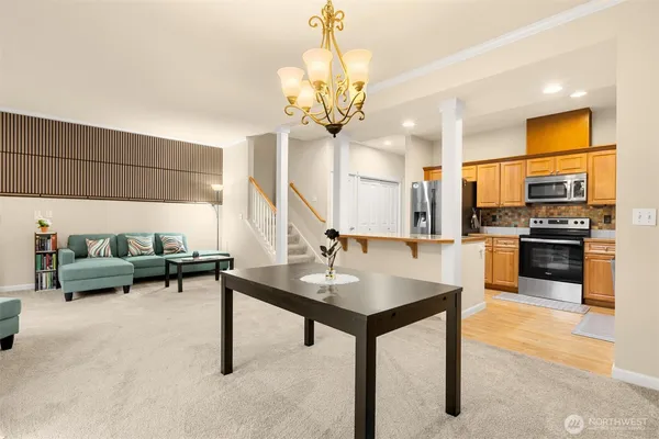 a view of kitchen with furniture and a chandelier