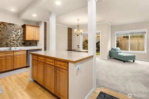 a large white kitchen with a large window