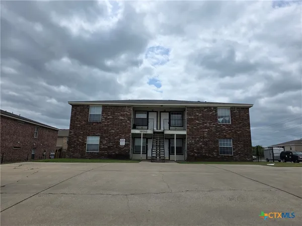 a view of a house with a yard and garage