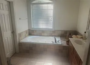 a bathroom with a bathtub and a sink