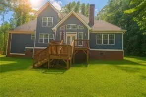 a front view of a house with a yard table and chairs